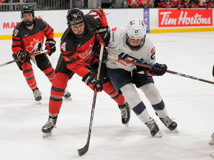 Nov 21, 2021; Kingston, Ontario, CAN; Canada defence Renata Fast (14) USA forward Britta Curl (27) battle for position during the third period of a Rivalry Series women's hockey game at Leon's Centre. Mandatory Credit: John E. Sokolowski-USA TODAY Sports